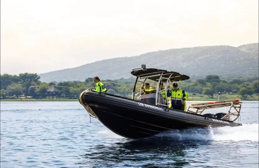 The unit's rescue boat at speed on Hartbeespoort Dam, its crew in hi-vis